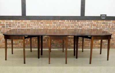Banquet table: A late 18th/early 19th century George III Mahogany banquet table. Three part design with two additional leaves, "D" ends with gate legs and inlaid skirt detail with simple tapered legs. Older refinish
