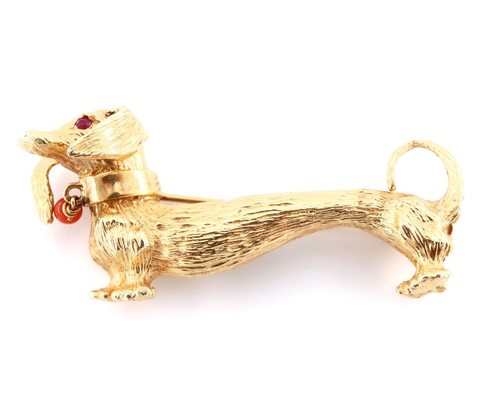 14k Gold Dachshund Brooch: A 14k Gold Dachshund form brooch with Ruby chip eyes and Coral bead collar tag. Marked "14k". 8.9 grams total. Slight wear. 1 3/4" long. ESTIMATE $400-600