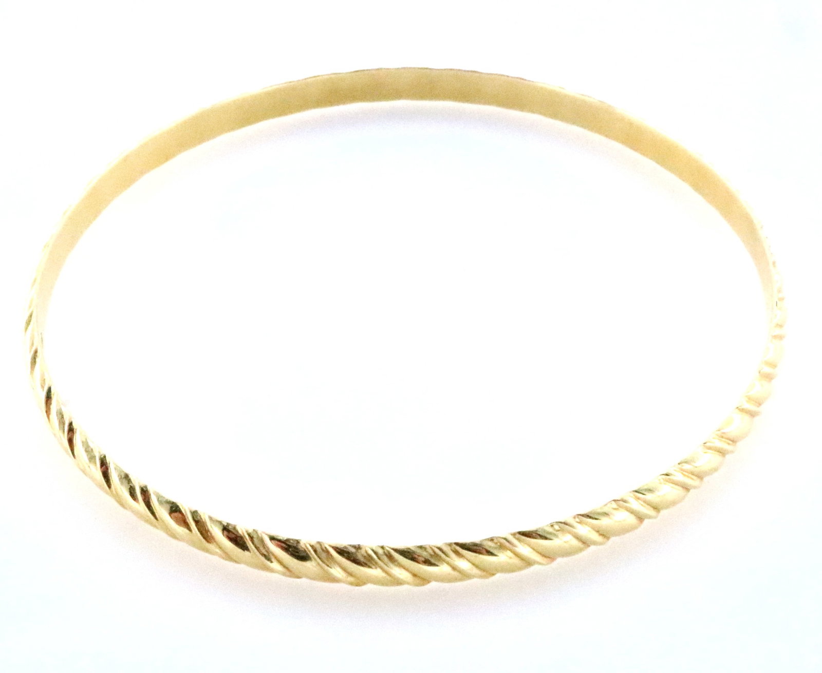 Simon Sobie & Co. 14k Gold Bangle: A 14k Gold bangle bracelet with gadrooned design by Simon Sobie & Co., New York. Marked "S 14k S" in cartouche. 12.3 grams total. Minor surface wear. 7 3/4" interior circumference. ESTIMATE $600-800