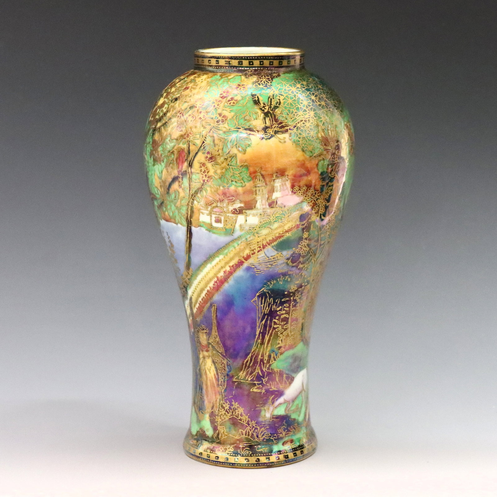 Wedgwood Fairyland Vase: An early 20th century Wedgwood Fairyland Lustre vase designed by Daisy Makeig-Jones. Shape #2046, baluster porcelain form with polychrome "Rainbow/Bifrost" decoration and Gilded detail. Illustrated Pl
