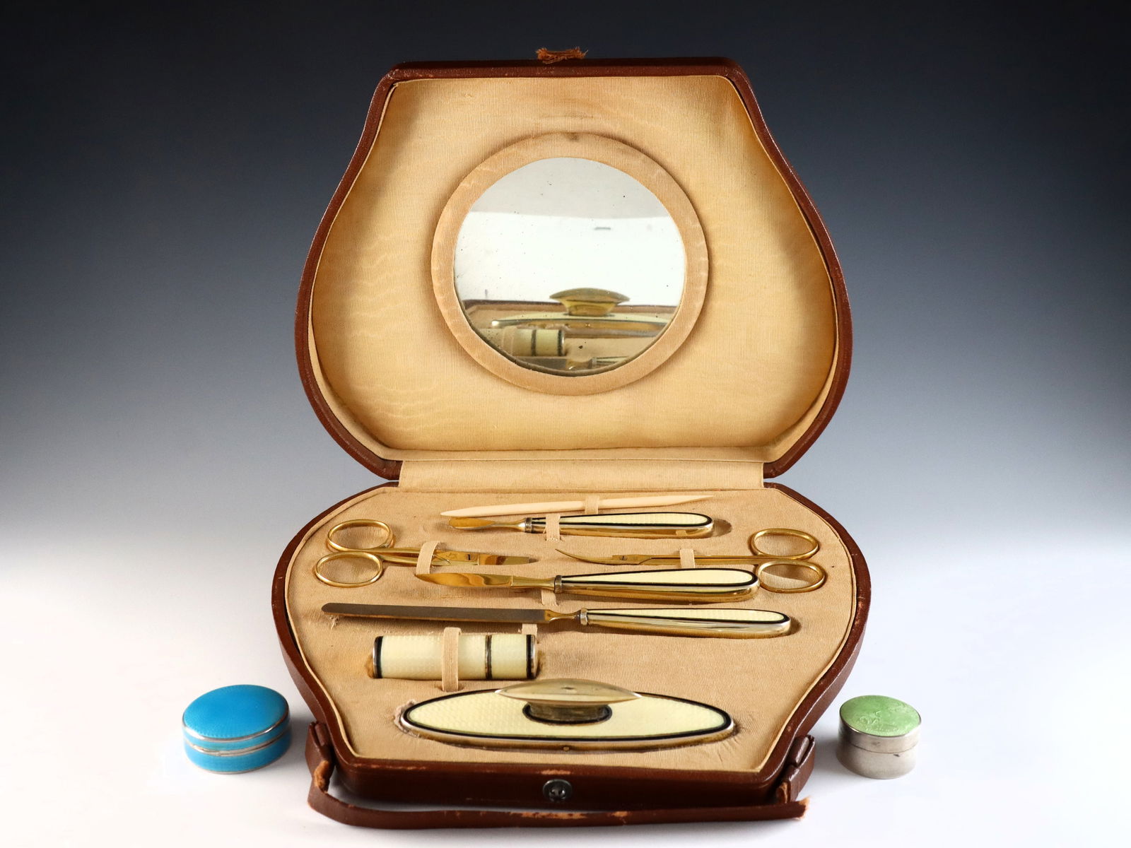 Silver Guilloche Manicure Set & 2 Snuff Boxes: An early 20th century Silver manicure kit and two Silver snuff boxes with Guilloche enamel decoration. Includes a Yellow eight piece German manicure set with .935 Silver handles/mounts in the original
