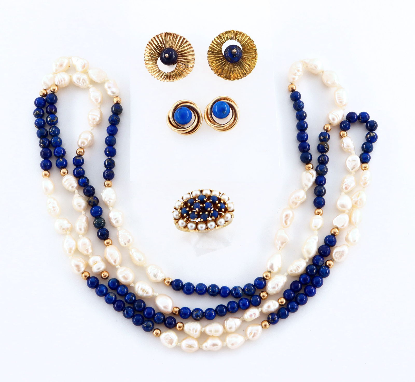4 pc 14k Gold & Lapis Lazuli Jewelry: Four pieces of 14k Gold and Lapis Lazuli jewelry. Includes a beaded necklace with Baroque Pearls and 14k spacer beads, a cluster ring with Pearls, and two pairs of earrings. Both pair of earrings and