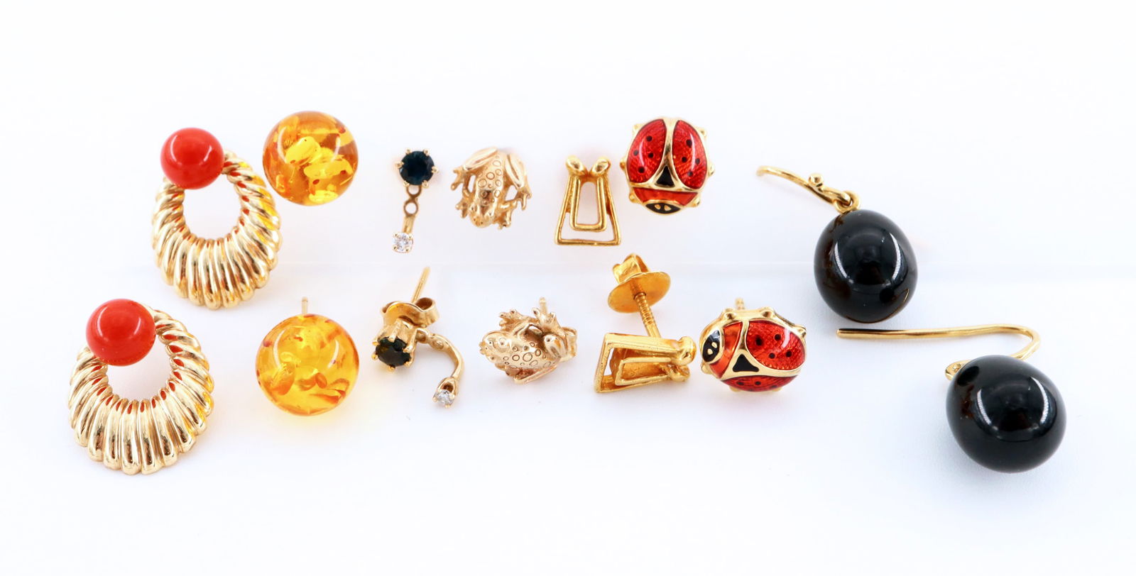 7 pr 14k/18k Gold Earrings: Seven pairs of 14k/18k Gold earrings. Various styles, includes six 14k pairs with Coral, Blue Topaz, Amber and enameled decoration, and a pair of 18k drop earrings with Black glass beads. Each marked