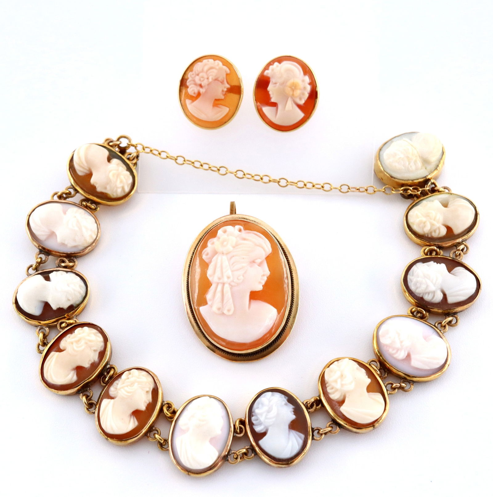 3 pc Gold Cameo Jewelry: Three pieces of carved shell Cameo jewelry with Gold frames. Includes a child's 10k bracelet, an Italian 14k pendant/brooch, and a pair of 18k earrings. Marked "10k", "14k" and "750". 12.9 grams total