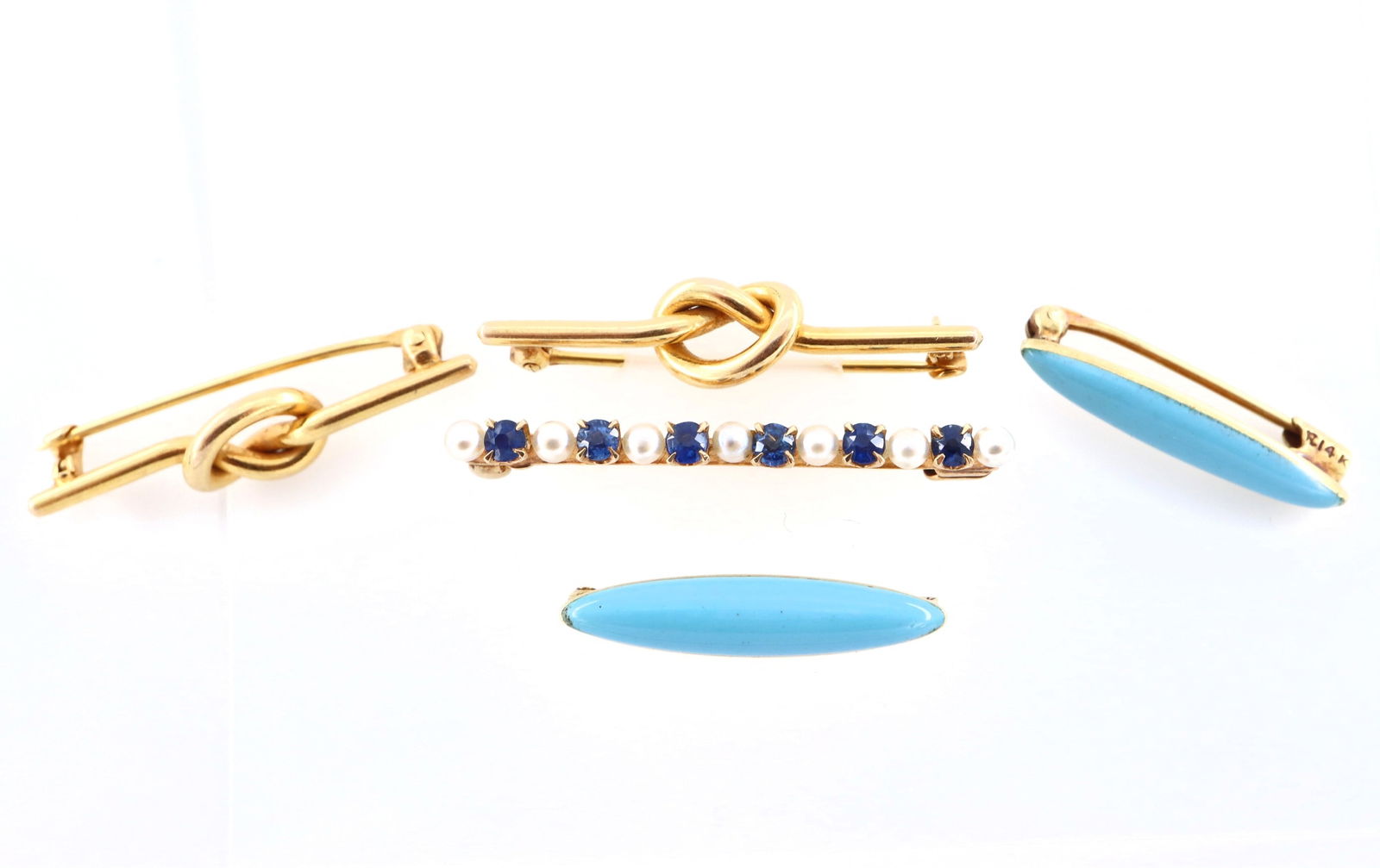 5 14k Gold Bar Pins: Five 14k Gold bar pins. Includes one with alternating Pearls and Blue Topaz stones, two with knotted design, and two with Blue enamel decoration. Each marked "14k". 6.6 grams total. Minor surface wear
