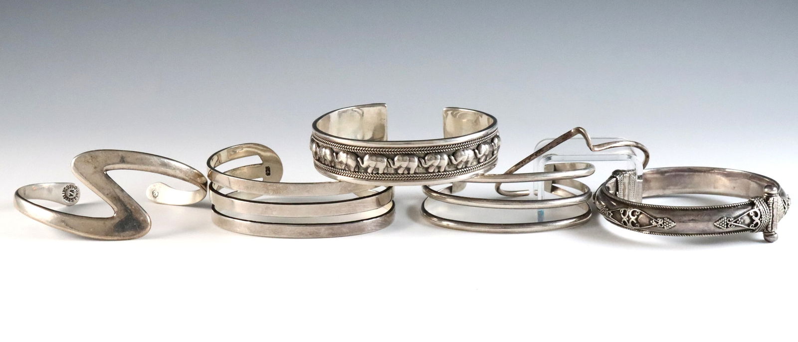 6 Sterling Bracelets: Six Sterling Silver bracelets. Various cuff and hinged designs. Each marked "Sterling" or "925". 4.53 troy ozs total. Some wear. Up to 6 3/4" interior circumference. ESTIMATE $200-400