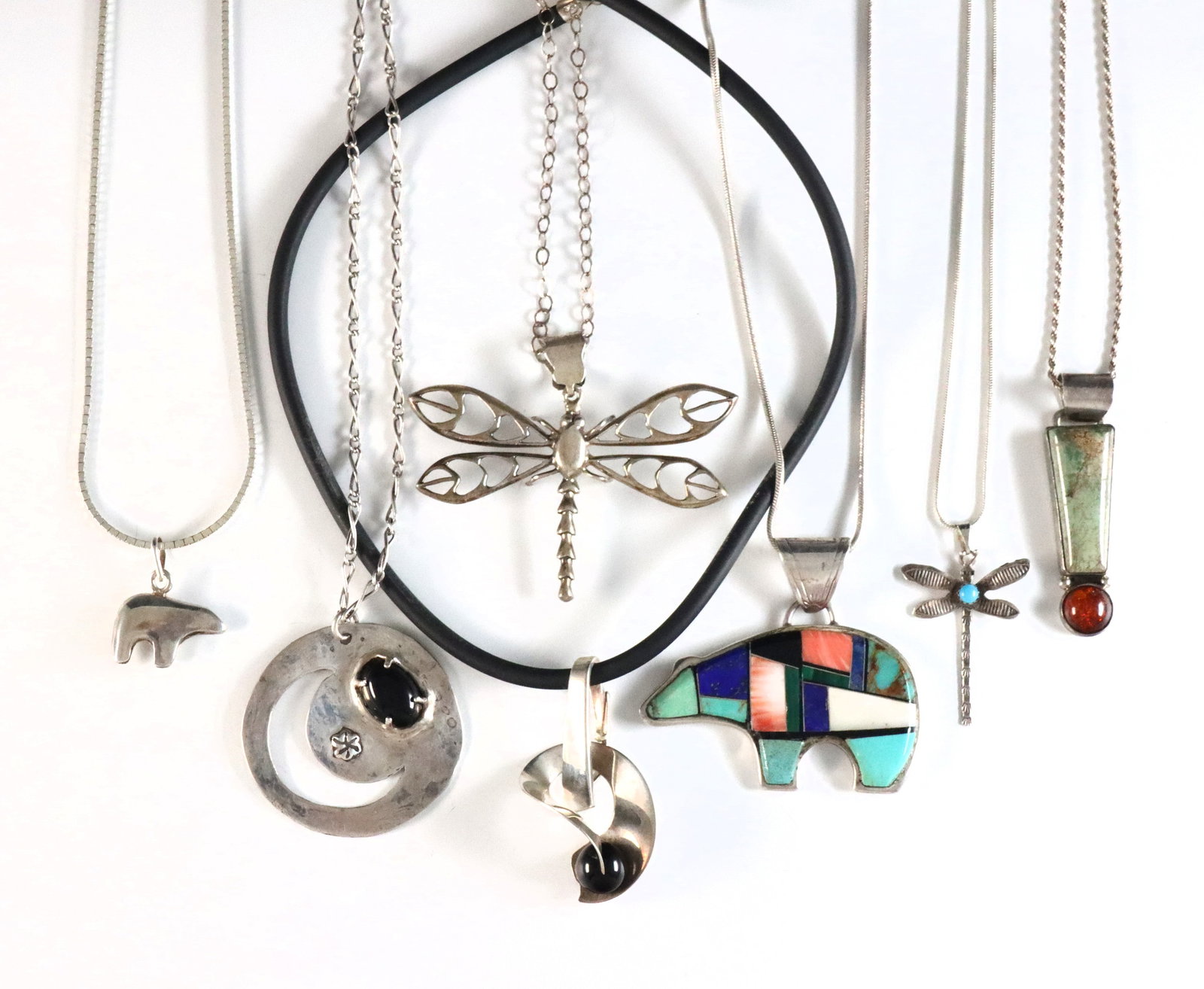 7 American Southwest Sterling Necklaces: Seven American Southwest style Sterling Silver pendant necklaces. Various bear, dragonfly and abstract designs. Each marked "Sterling", "925" or tested Sterling. 3.49 troy ozs total. Some wear. Up to 