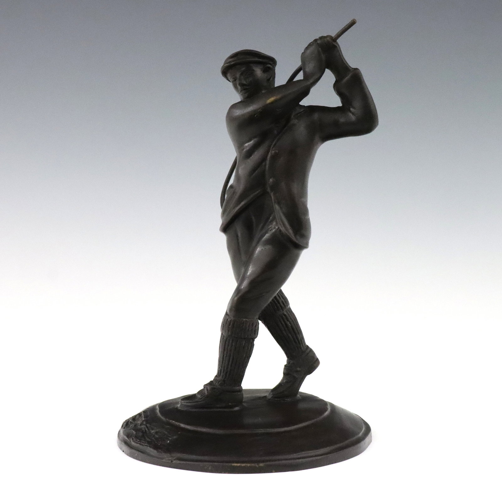 Bronze Figure of a Harry Vardon: A 20th century Bronze figure of Harry Vardon. Depicts the golfer mid swing with incorporated base and dark patina. Slight wear to patina, club with minor bends. 9" high. ESTIMATE $100-200