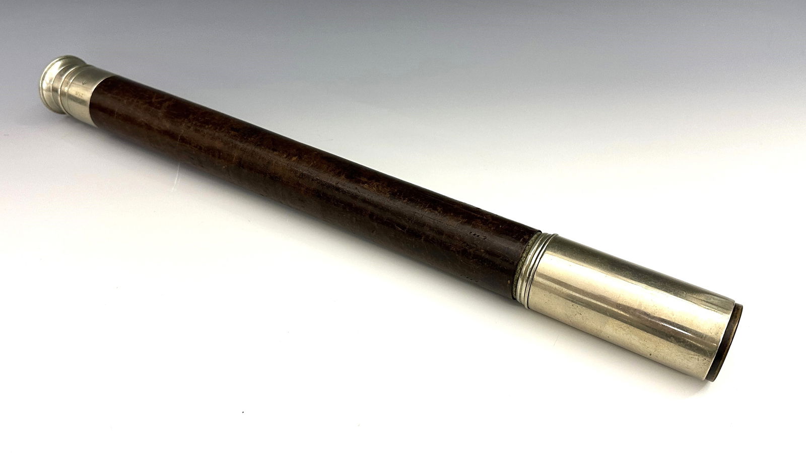 Cooke & Sons WWI Single-Draw Telescope: An English WWI Period Officer of the Watch single-draw telescope by T. Cooke & Sons. Nickel plated with leather covered barrel, 1 1/2" objective lens, sun shade and sliding lens cover. Marked "T. Cook