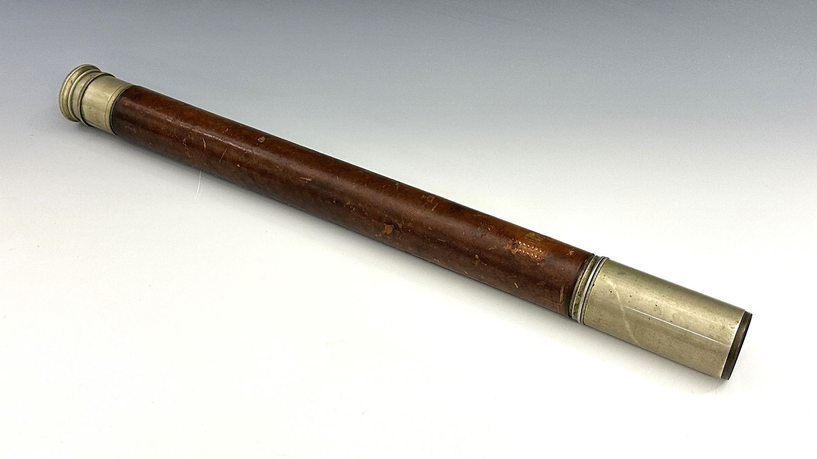 H. Hughes & Sons WWI Single-Draw Telescope: An English WWI Period Officer of the Watch single-draw telescope by Henry Hughes & Sons. Nickel plated with leather covered barrel, 1 1/2" objective lens, sun shade and sliding lens cover. Marked with