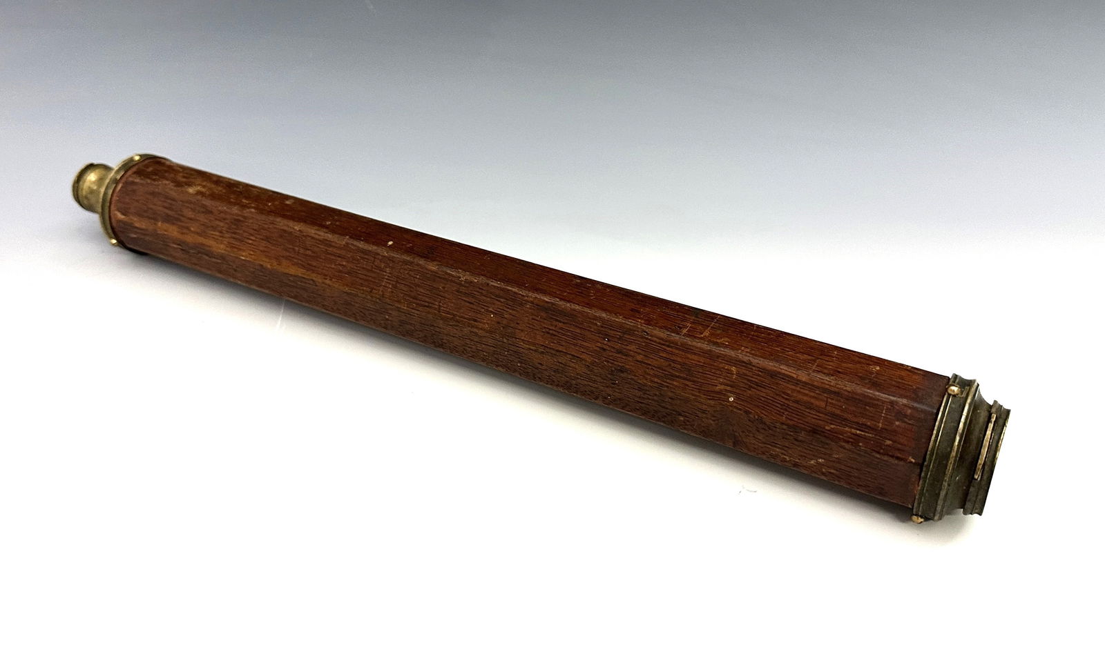 Early Brass Single-Draw Telescope: A late 18th century Brass single-draw telescope. Octagonal Walnut barrel with 3/4" objective lens and sliding Brass lens covers. Some wear to patina, old finish with some wear and shrinkage, small pun