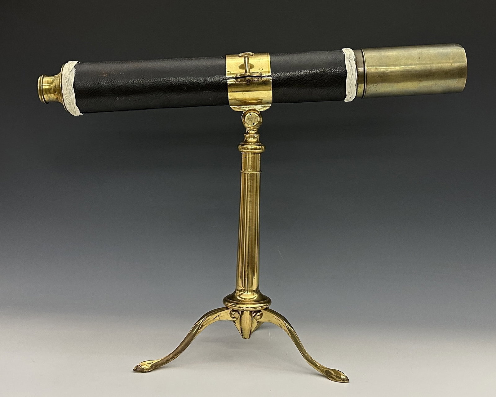 Mounted Brass Single-Draw Telescope: A late 19th century Brass single-draw telescope mounted on a Brass tabletop stand. Shagreen covered barrel featuring sailor's knotwork decoration with 1 3/4" objective lens, sun shade and sliding Bras