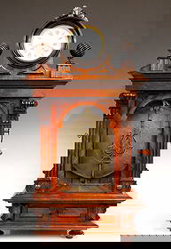 Symphonion Coin-Op Music Box With Clock: A late 19th century Symphonion coin-op music with the original Junghans clock incorporated into the crest. Junghans 30 hour time only timepiece with lever escapement, original papered metal dial with