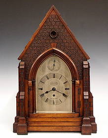 Gothic Revival Bracket Clock: A late 19th century English Gothic Revival Period bracket clock. 8-day chain driven triple fusee time and strike movement with quarter hour chiming on eight bells, Silvered dial with engraved decorati