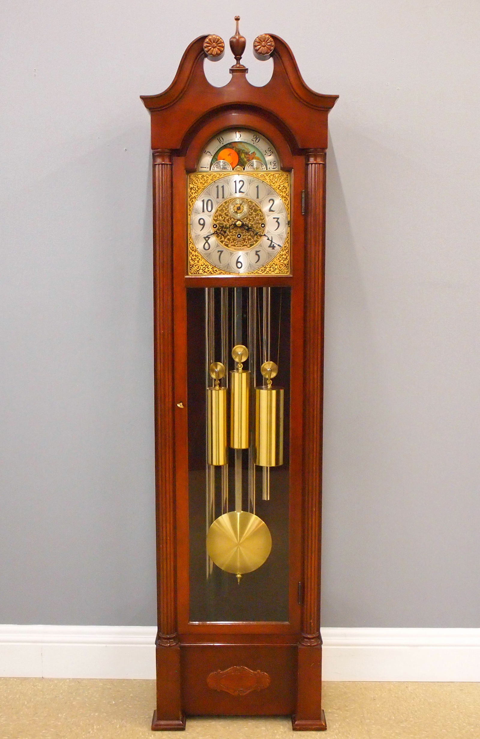 Herschede Grandfather Clock: A 1950's Herschede Hall Clock. 8-day weight driven time and strike movement with quarter hour Westminster chiming on five tubes, Brass filigree dial with upper moon phase and Arabic numerals, serial #