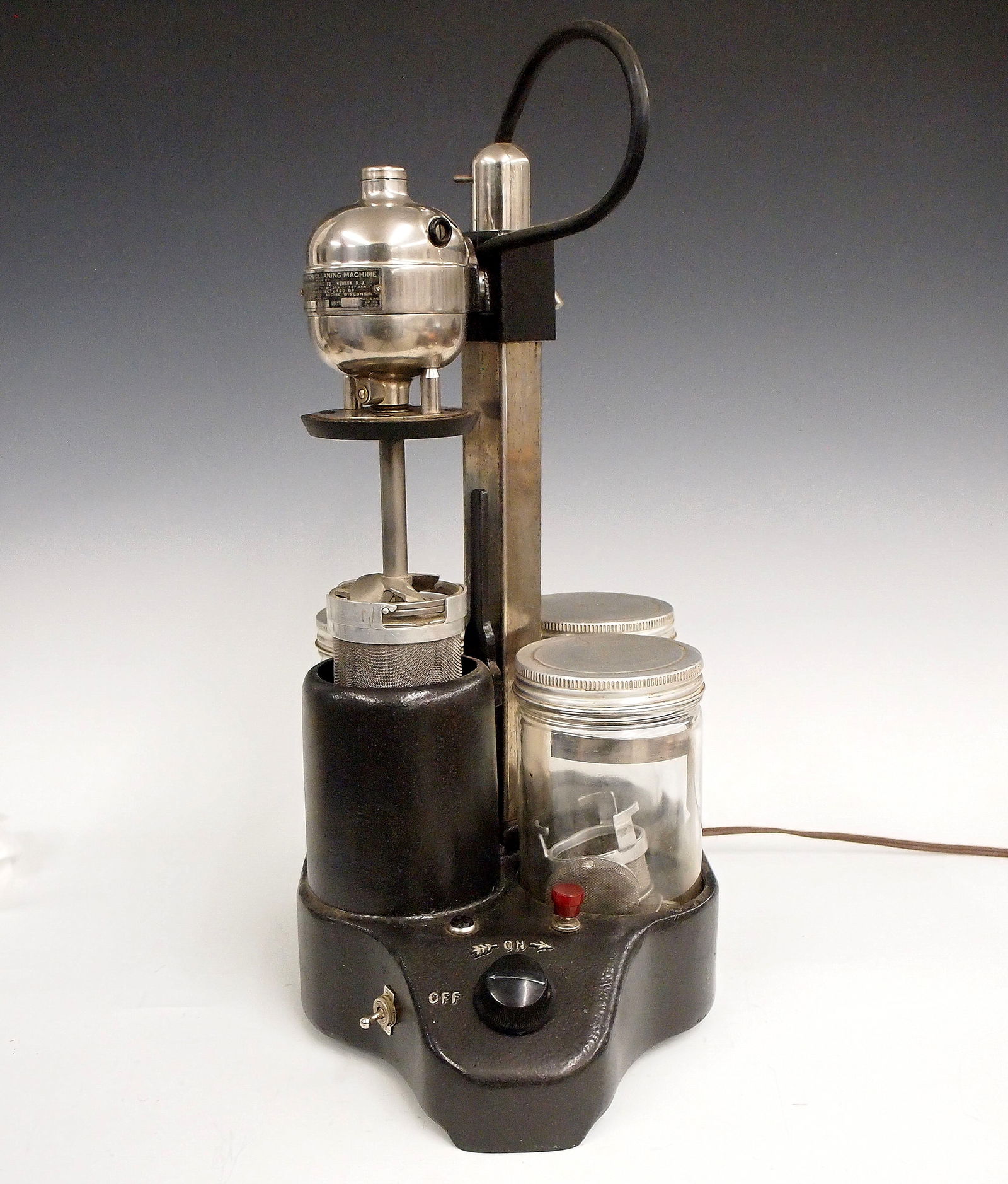 Vintage L & R Watch Cleaner: A vintage L & R watch cleaner. Three jar design with rotating head on a Japanned Iron base. Some wear. Approx. 19" high overall. ESTIMATE $400-600