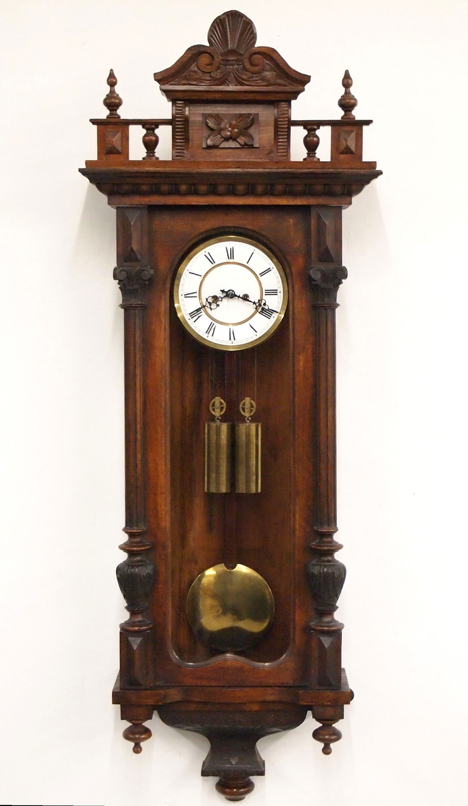 2 Weight Vienna Regulator Wall Clock: A 19th century Vienna Regulator wall clock. 8-day weight driven time and strike movement with two-part porcelain dial and Roman numerals. Altdeutsch style Walnut case features a shaped gallery crest w