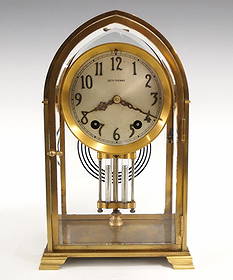 Seth Thomas Gothic No. 0 Crystal Regulator: An early 20th Seth Thomas Gothic No. 0 Crystal Regulator. 8 day time and strike movement with convex Silvered dial and applied Arabic numerals with faux Mercury pendulum. Brass case features an arched