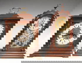 2 Mantel Clocks: Lot of two mantel clocks. Includes an Ansonia 30-hr Cottage clock and a Linden "Triple Chime" 8-day with quarter hour chime with balance wheel escapement. Original finishes with some wear, running whe