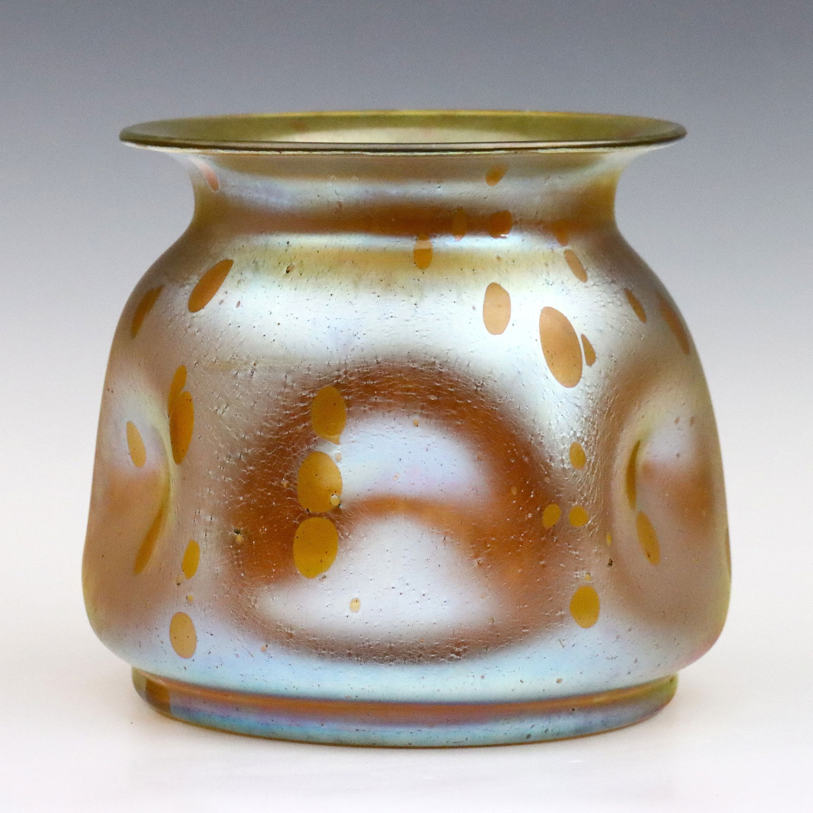 Loetz Astraea Art Glass Vase: A turn of the century Loetz "Astraea" Art Glass vase. Bulbous form with flared rim and pinched body with "Oil Spot" finish on an Iridescent Gold ground. Unsigned. Minor surface wear, a few darkened su