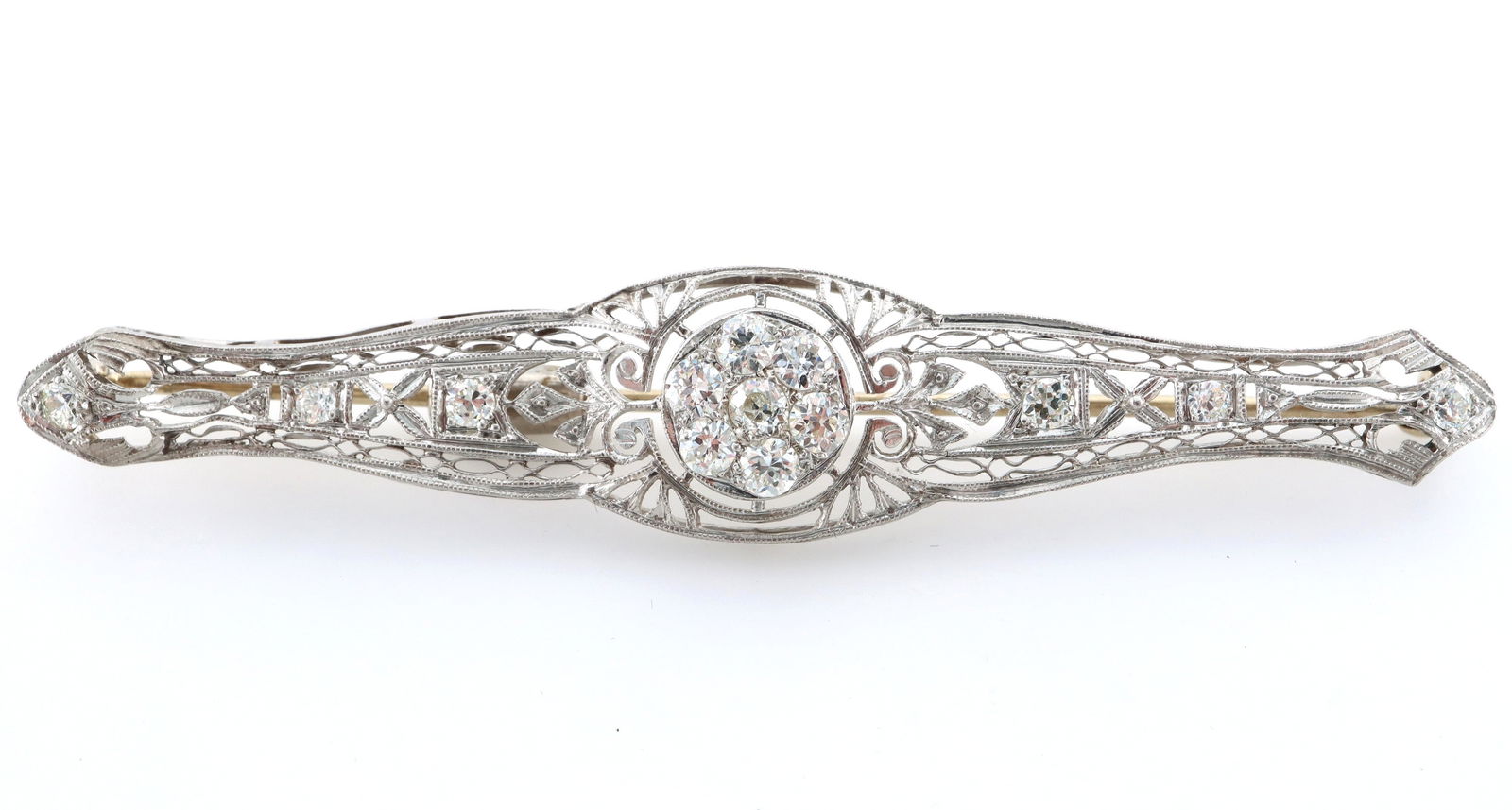 Art Deco Platinum & 14k Gold Diamond Brooch: An Art Deco Period Platinum and 14k White Gold brooch with Diamonds. Features a Platinum filigree top having a circular center with seven round prong set Diamonds, a combination of brilliant cut and O