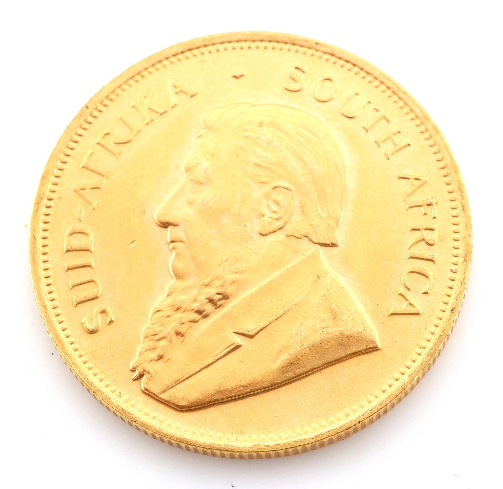 1980 South African Gold Krugerrand: A 1980 South African 1oz Gold Krugerrand. 34.0 grams total. Minor surface wear, minor denting along reverse edge. ESTIMATE $2,000-3,000