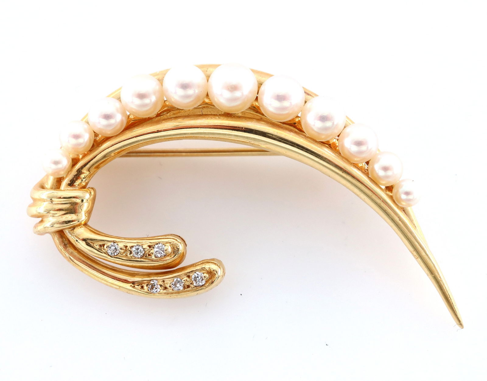 14k Gold, Pearl & Diamond Brooch: A vintage 14k Gold scrolled brooch with Pearls and Diamond accents. Features a pierced design with graduated Pearls and Diamond chips. Marked "14k" and "585". 7 grams total. Slight surface wear. 2" lo