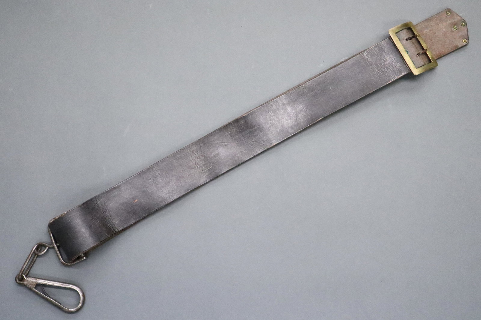 U.S. Calvary Carbine Sling: A 19th century U.S. Civil War Era leather calvary carbine sling. Brown leather sling with Brass buckle and tip, with a Steel swivel carabiner. Leather impressed "Rock Island Arsenal / D.C.L." and cara