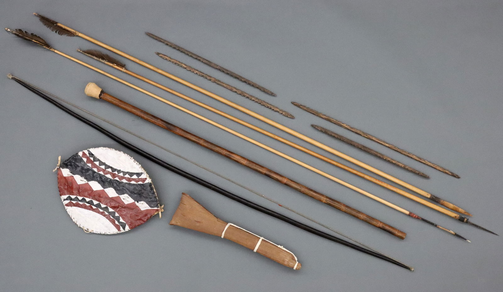 Collection of Tribal Weaponry: A collection of tribal weaponry. Several Venezuelan pieces from the Piaroa people including a hardwood bow, three bamboo spears, a wooden blow dart and a bentwood quiver full of blow darts, with a sma
