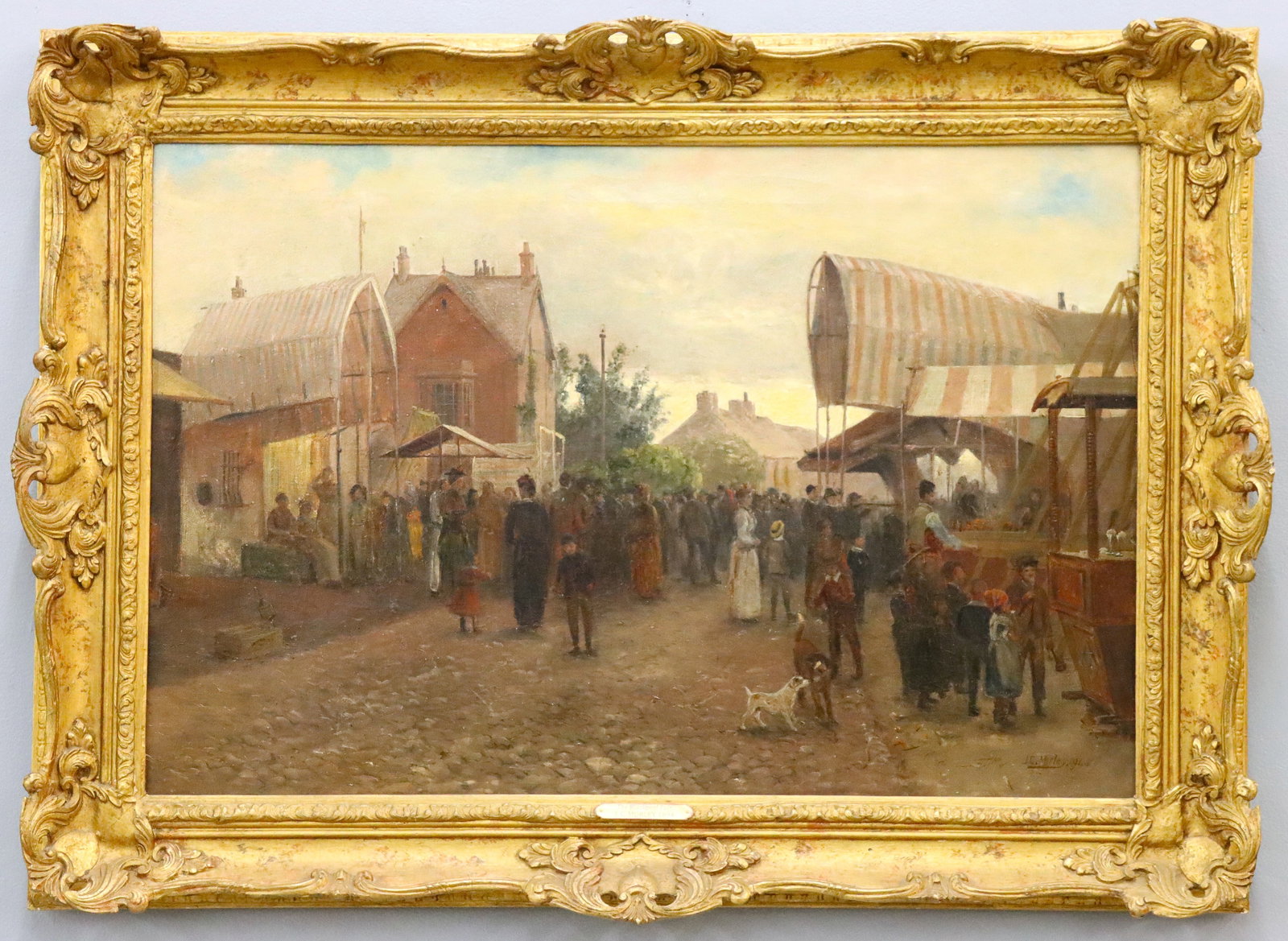 J.C. Morley Village Carnivale Scene: J.C. Morley, British, 19th/20th century. A late 19th century oil on canvas genre scene depicting a village carnival, with an ice cream vendor, games and attractions amidst cobbled streets with village