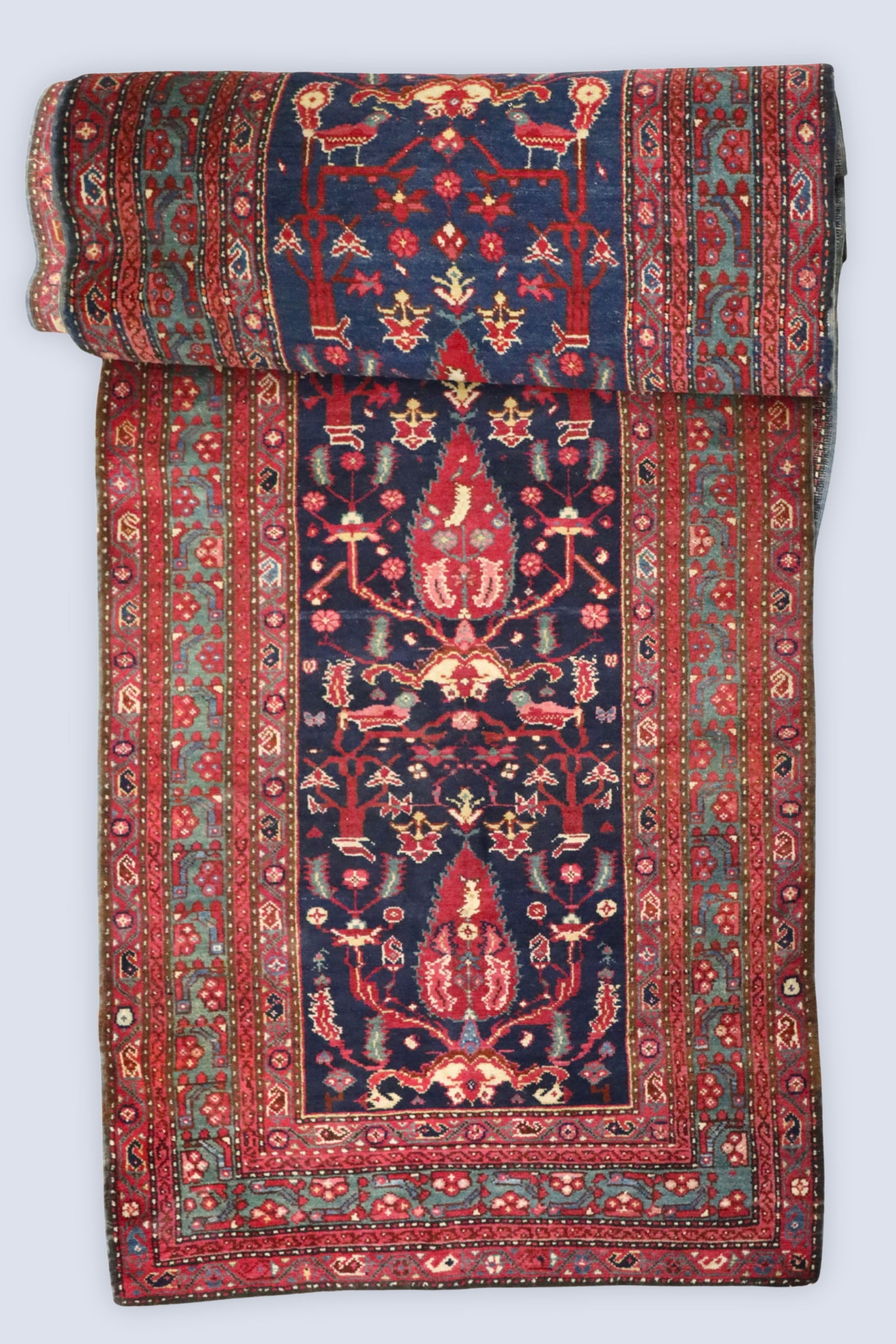 Persian Tree of Life Runner: A vintage 3.5' x 22' Persian runner. Multi-color Tree of Life design with Birds on a Navy Blue field within multiple Brick Red borders with floral decoration. Cloth label at back reads "Made in