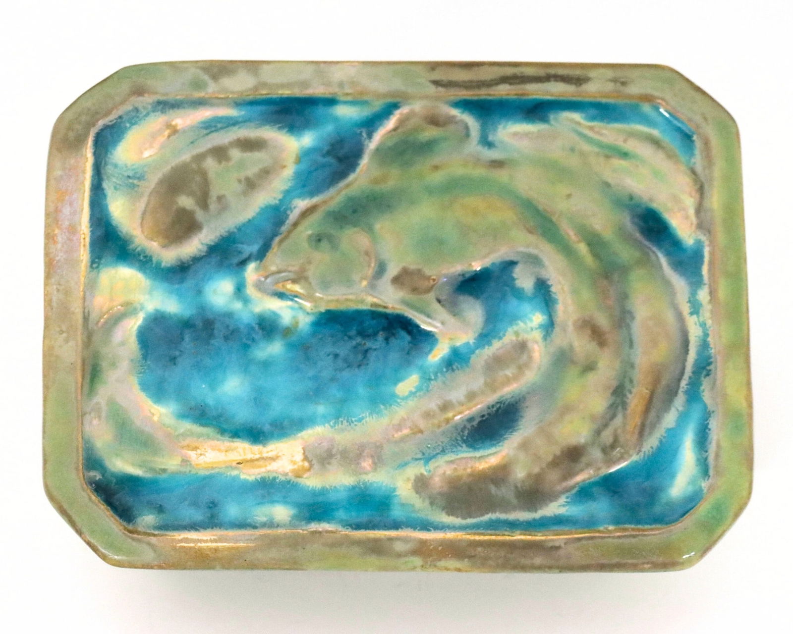 Pewabic Pottery Covered Box: A mid 20th century Pewabic Art Pottery covered box. Rectangular form with canted corners, featuring a relief Koi fish design at the lid and Iridescent glaze in mottled shades of Green and Blue. 