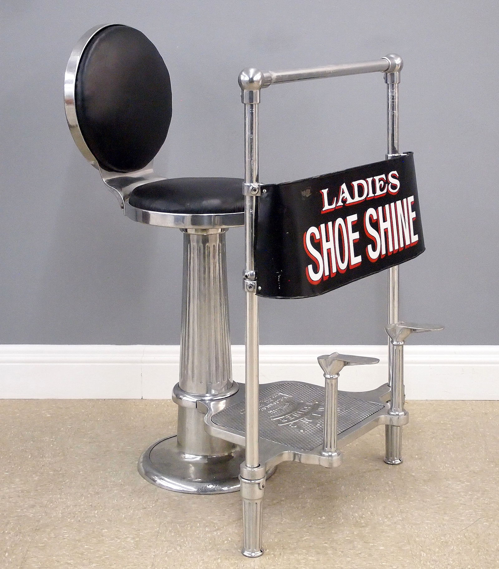 Ladies Shoe Shine Stand: An early 20th century "King Shiner" ladies shoe shine stand by H. C. Schulse, Inc. N.Y. Iron construction with polished Nickel finish features an upholstered back and seat and lower footrests with