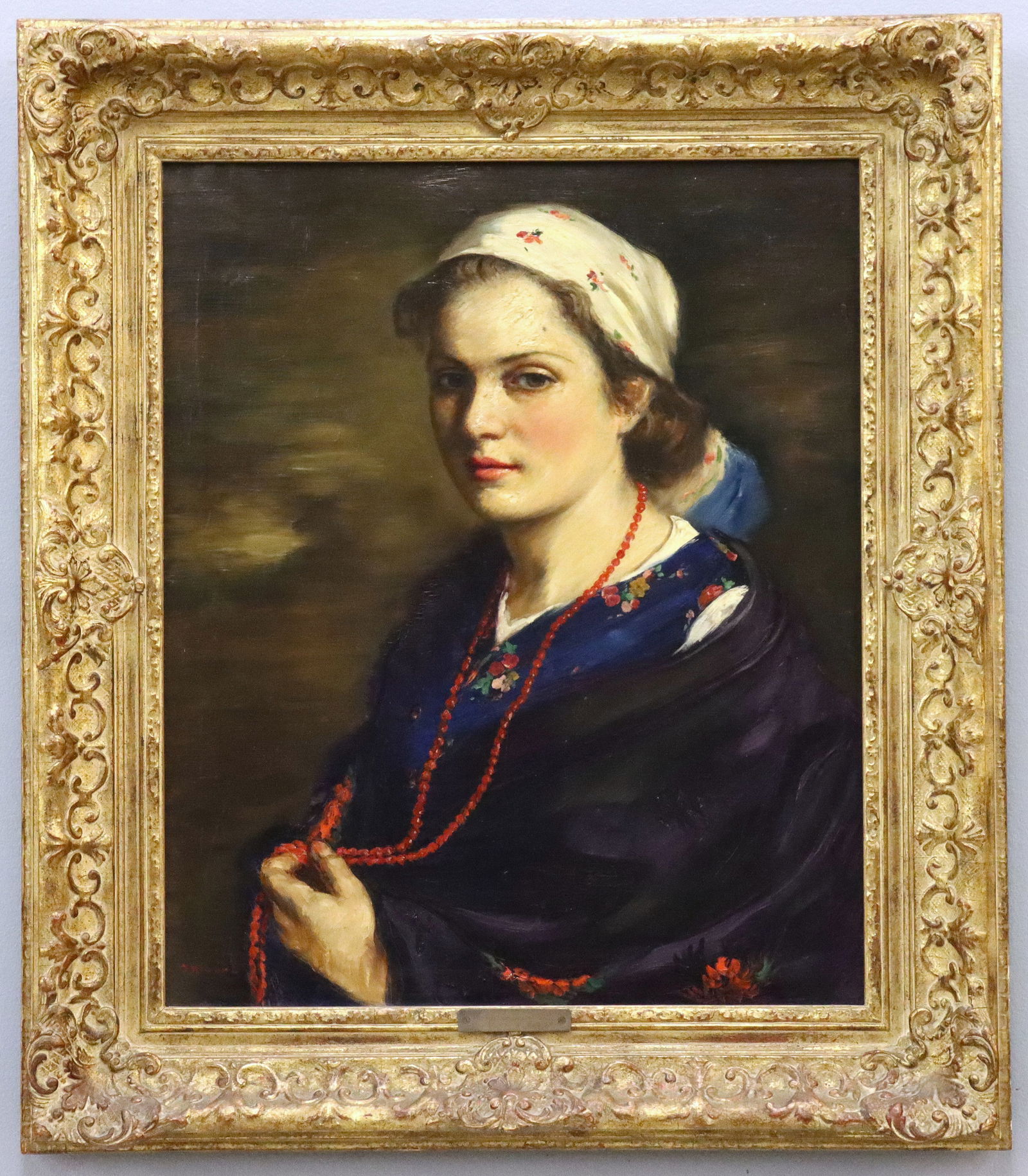 L. R. Molnar Hungarian Peasant Girl: Lajos Rezes Molnar, Hungarian, 1896-1989. An oil on canvas portrait of a young woman, depicted seated and in half length, wearing traditional Hungarian attire in vibrant shades of Purple, Red, Blue,