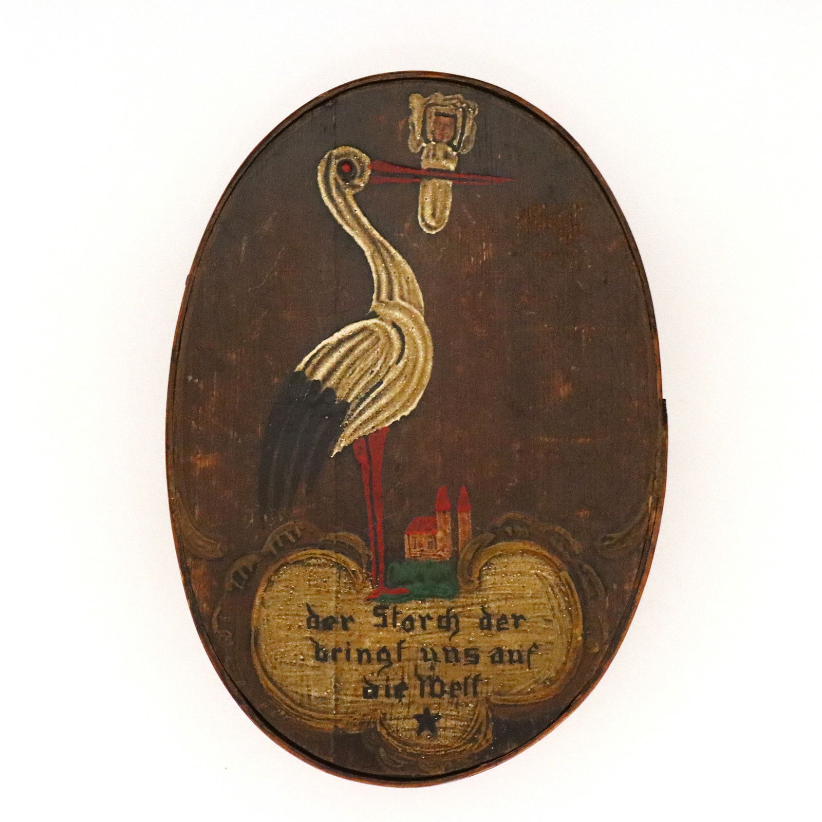 German Bentwood Box: A 19th century German bentwood box. Oval form with lift-off top and polychrome decoration depicting a Stork with a baby above script reading "Det Storch der Brings us auf die Welt" ("The Stork Bring