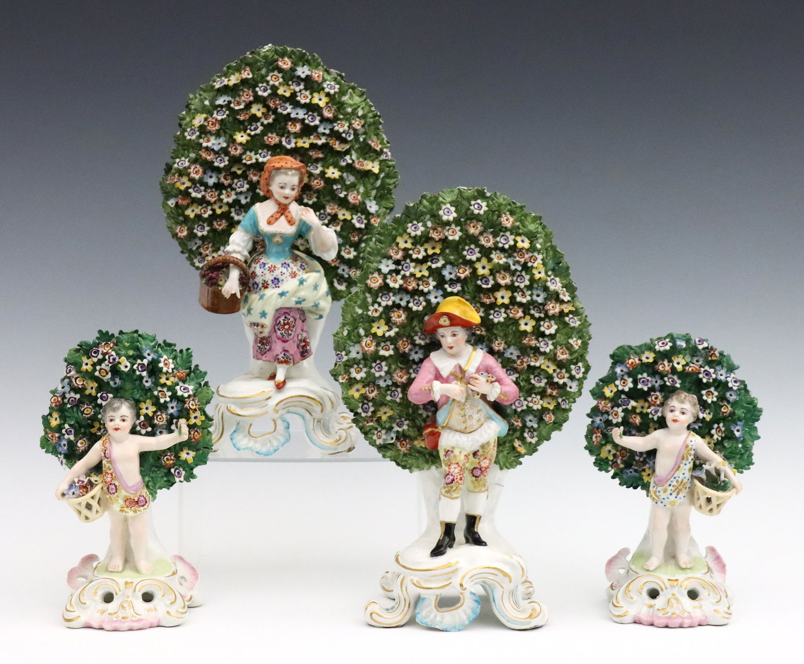 2 pr Chelsea Style Bocage Figures: Two pairs of late 18th to early 19th century Chelsea style porcelain bocage figures. Molded porcelain figures on scrolled Rococo style bases with polychrome hand-painted decoration and Gilded accents.