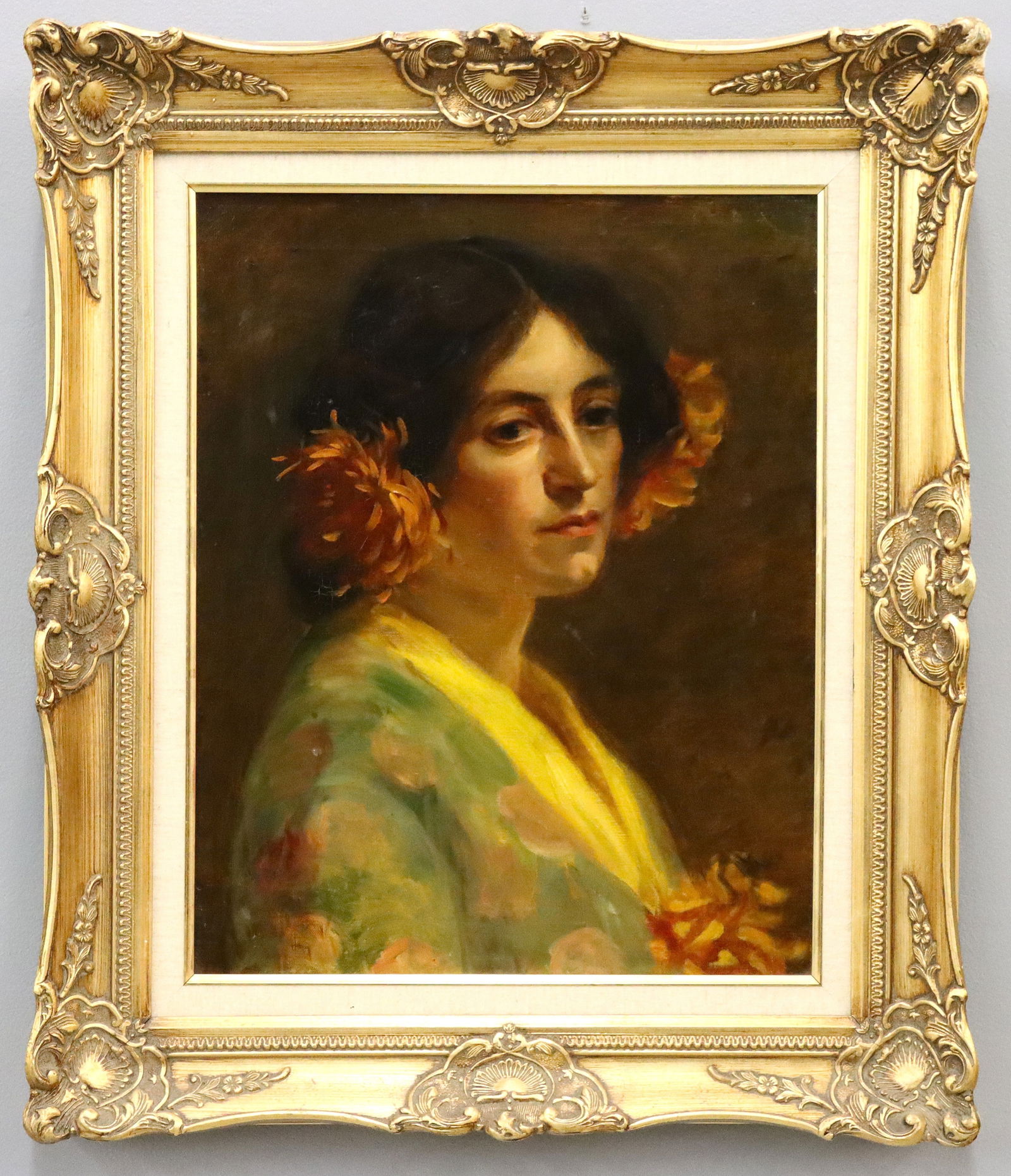 James Leeds Portrait of a Woman: A turn of the century oil on canvas portrait of a woman. Depicted bust length, turned towards the viewer with accents of large Orange flowers in her hair and hand. Signed "James Leeds" (n.d.) upper