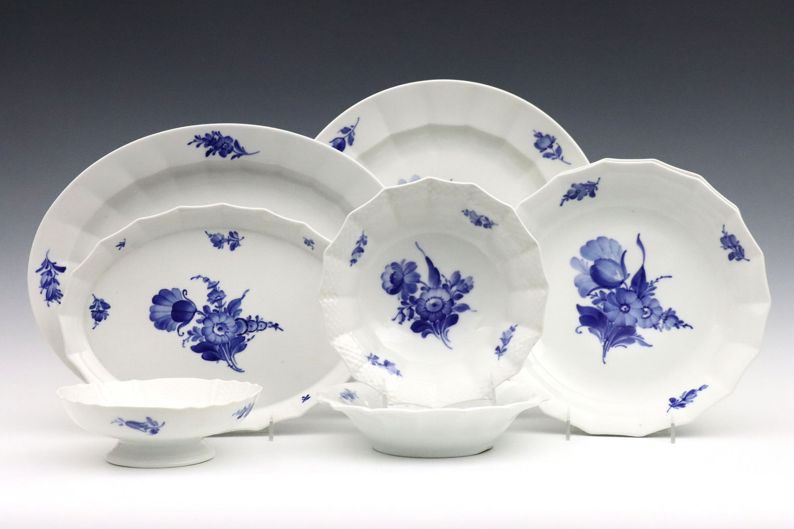 8 pc Royal Copenhagen Blue Flower Tableware: Eight 20th century Royal Copenhagen "Blue Flower Angular" pattern porcelain serving pieces. Includes serving platters and bowls. Printed "Royal Copenhagen" marks. Minor surface wear. Up to 14
