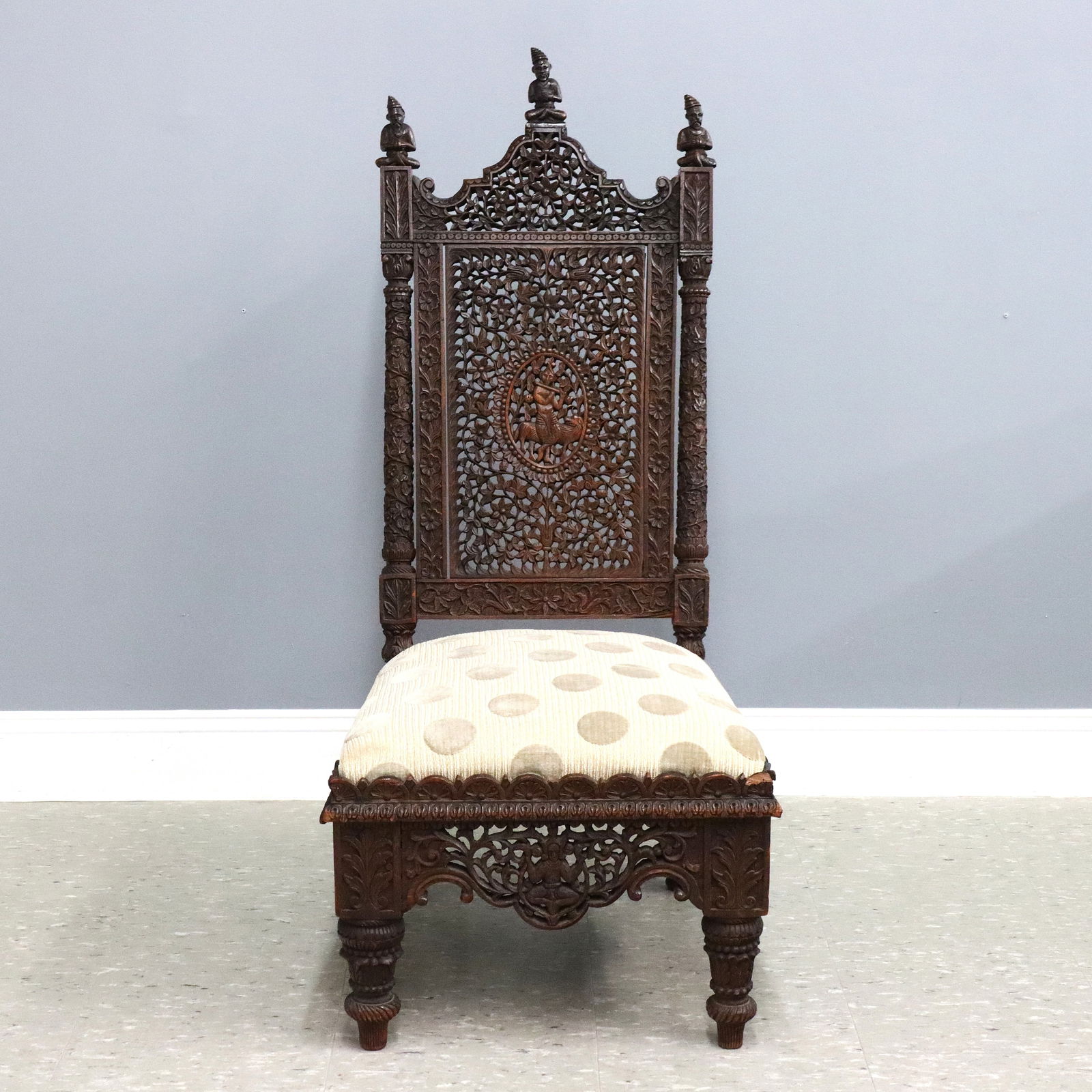 Anglo-Indian Side Chair: A late 19th century Anglo-Indian side chair. Rosewood construction with intricately carved design featuring a carved crest with figural finials over a pierced back with a central figural medallion