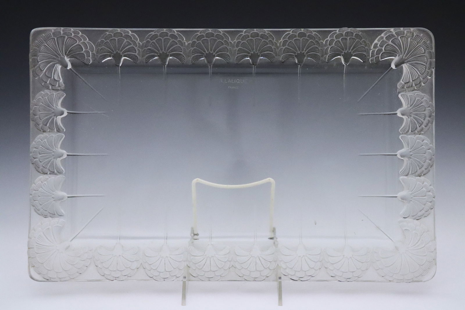 Lalique Oeillets Glass Dresser Tray: A 1930's Rene Lalique "Oeillets" pattern glass dresser tray. Rectangular tray with molded Carnation design and frosted detail. Marked "R. Lalique / France". Some surface wear, light scratches, two sma