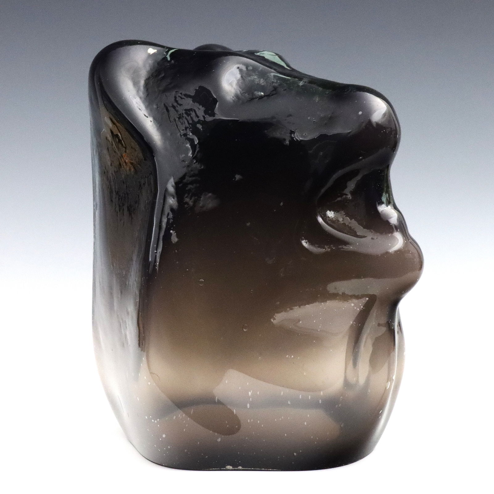 K. Lockau Art Glass Sculpture of a Dog Head: Kevin Lockau, Canadian, b. 1956. A 1980's Art Glass sculpture, titled "Black Dog's Head". Signed "K. Lockau" and dated "87" at side. Minor surface wear, a few small burst air bubbles from