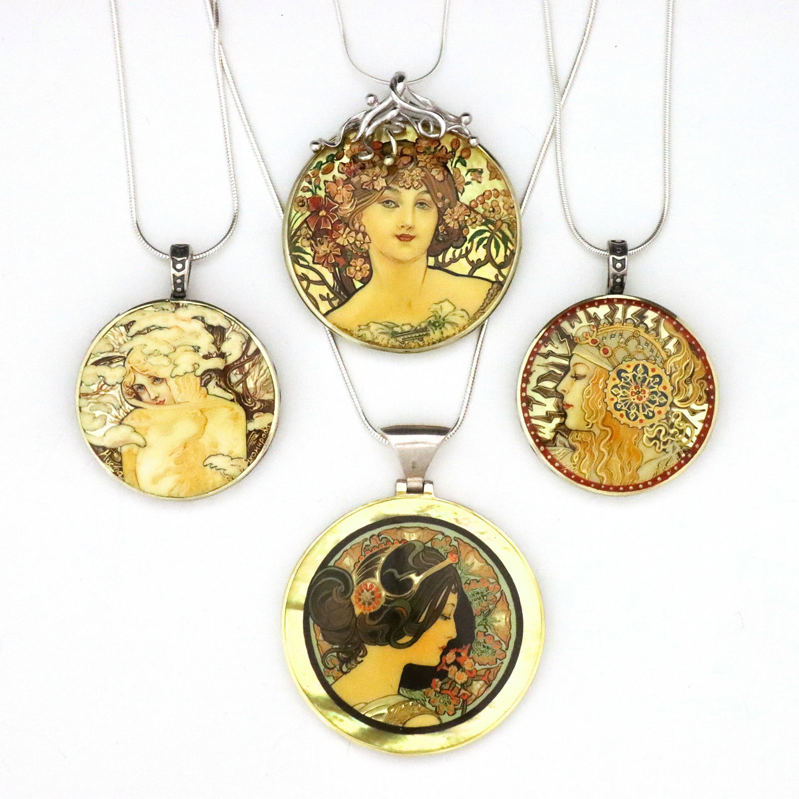 4 Mucha Sterling Silver Lacquer Necklaces: Four vintage Russian Sterling Silver lacquer necklaces after Alphonse Mucha. Circular form pendants with enameled lacquer miniatures after works by Mucha set in Sterling Silver frames. Three signed