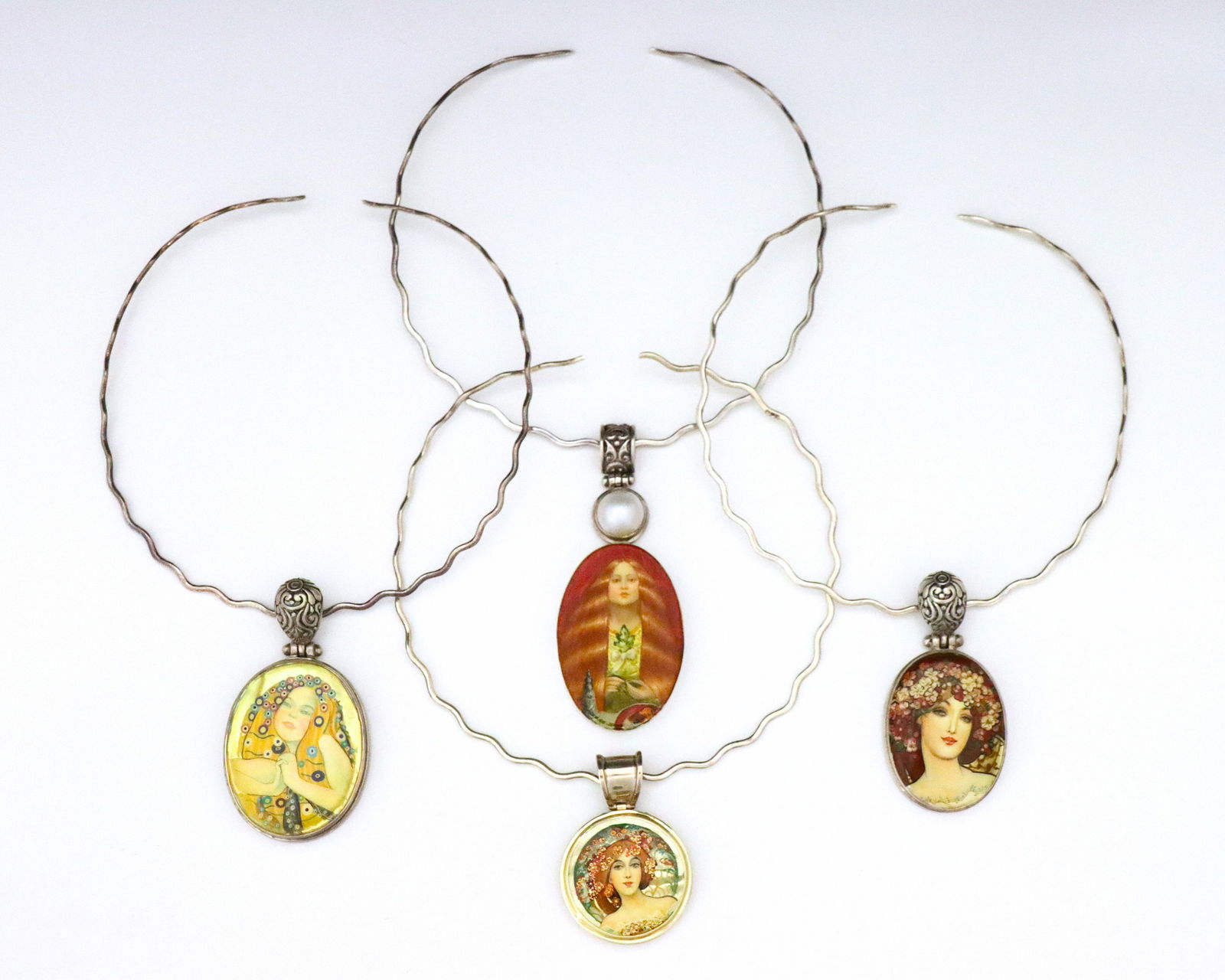 4 Mucha & Klimt Sterling Silver Lacquer Necklaces: Four vintage Russian Sterling Silver lacquer necklaces after Alphonse Mucha and Gustav Klimt. Various form pendants with enameled lacquer miniatures after works by Mucha and Klimt set in Sterling Silv