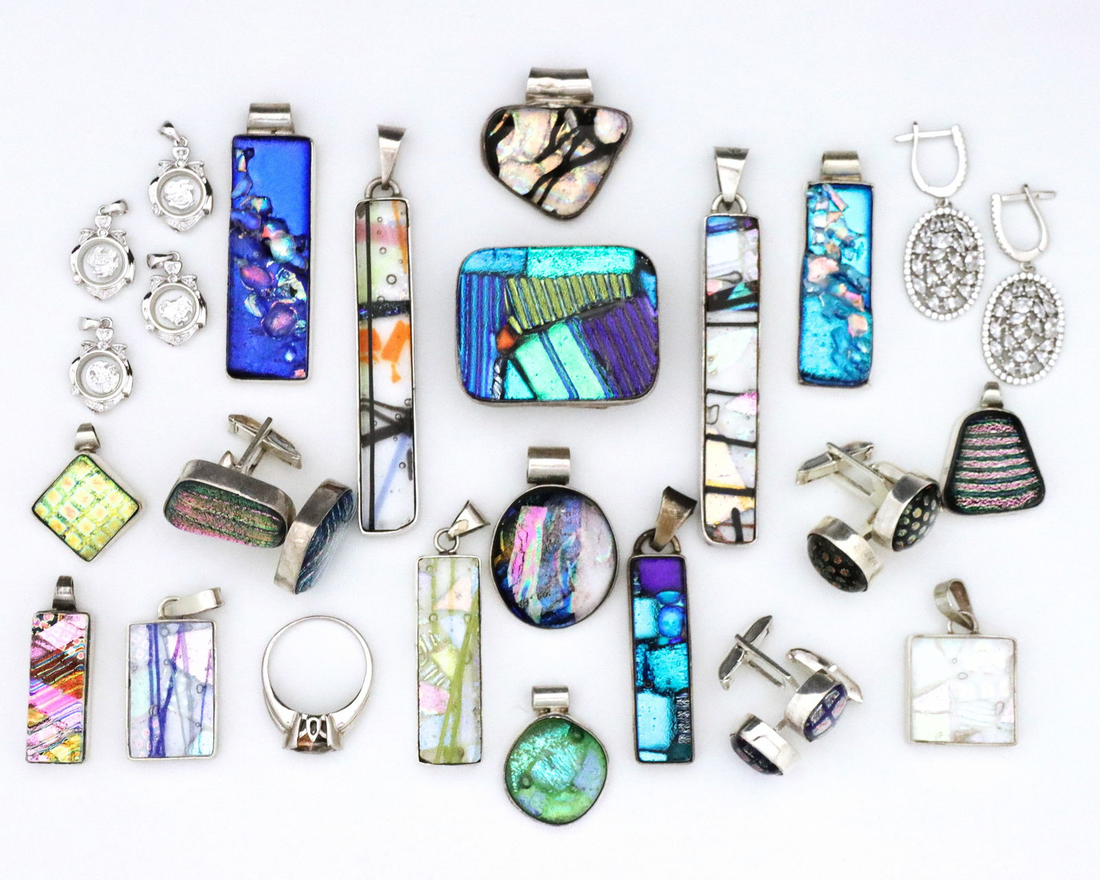 25 Sterling Accessories: Twenty-five vintage Sterling Silver accessories. Eighteen Mexican pieces with Dichroic glass including fourteen necklace pendants, three pairs of cufflinks, and a belt buckle, with four other gemstone