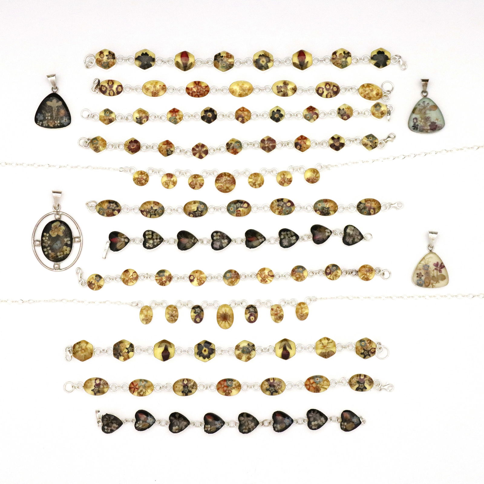 16 pc Sterling Jewelry with Pressed Flowers: Sixteen pieces of vintage Sterling Silver jewelry with pressed dried flowers set in enamel. Includes ten bracelets, four necklace pendants, and two necklaces. Each marked "925". Unworn, very slight we
