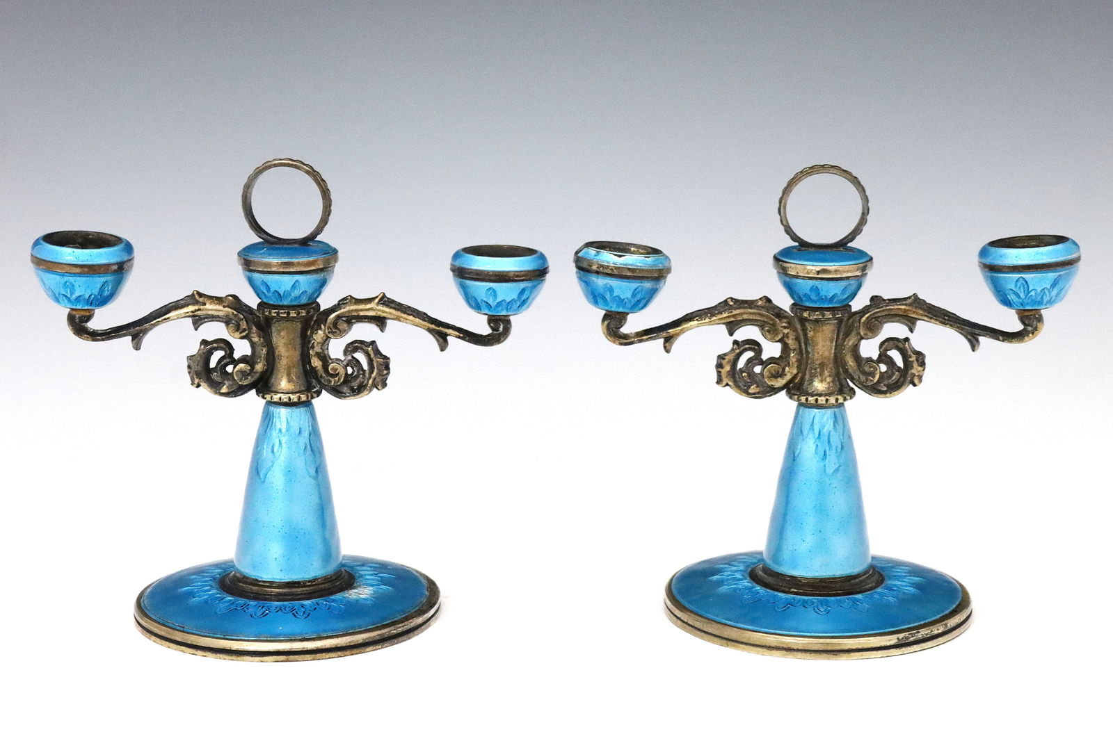 Pr Miniature Guilloche Silver Candelabra: A pair of early 20th century Continental .800 Silver candelabra with enameled guilloche decoration. Two light design with scrolled arms, Blue enamel with Gilded finish. Unmarked, tested .800 Silver or
