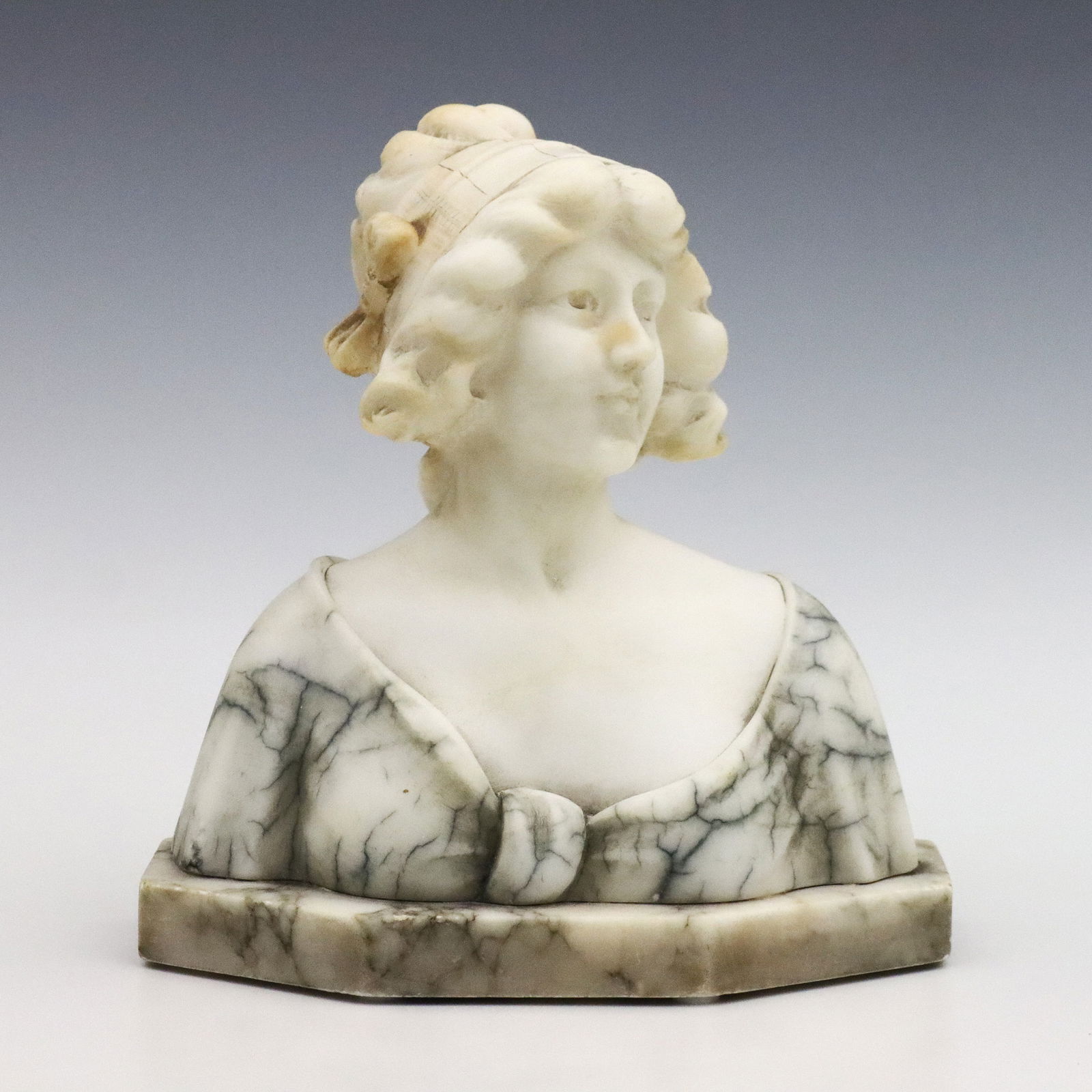 Alabaster Bust of a Woman: A turn of the century Italian carved Alabaster bust of a young woman wearing a bonnet. Signed "Made in Italy" at back. Minor surface wear, some surface grunge and discoloration. 7 x 7 1/2" high overal