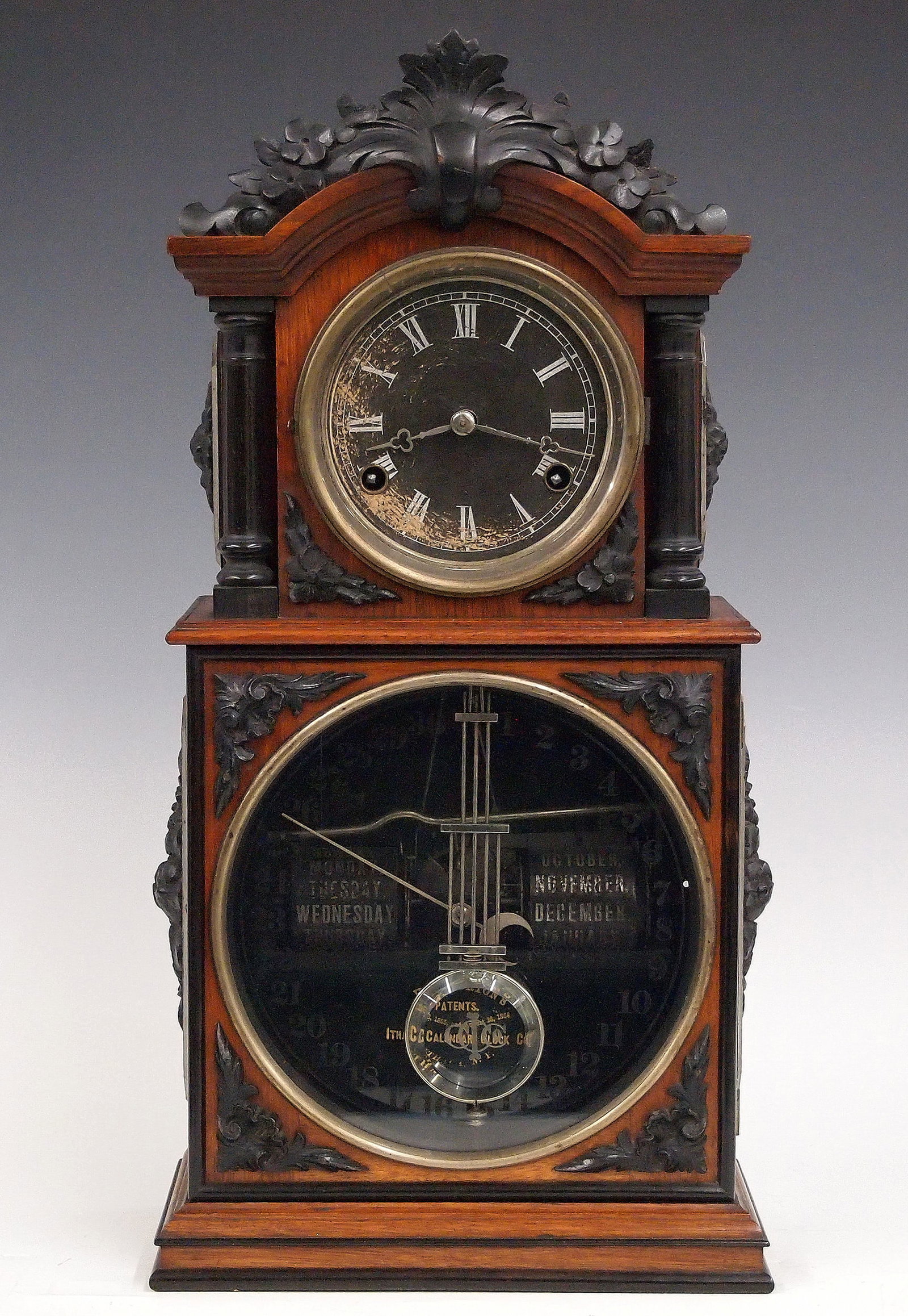 Ithaca Steeple Model Calendar Shelf Clock: A late 19th century Ithaca Steeple Model Calendar shelf clock. 8-day time, strike and alarm movement and lower calendar mechanism with apertures indicating day and month, papered metal dials with Roma