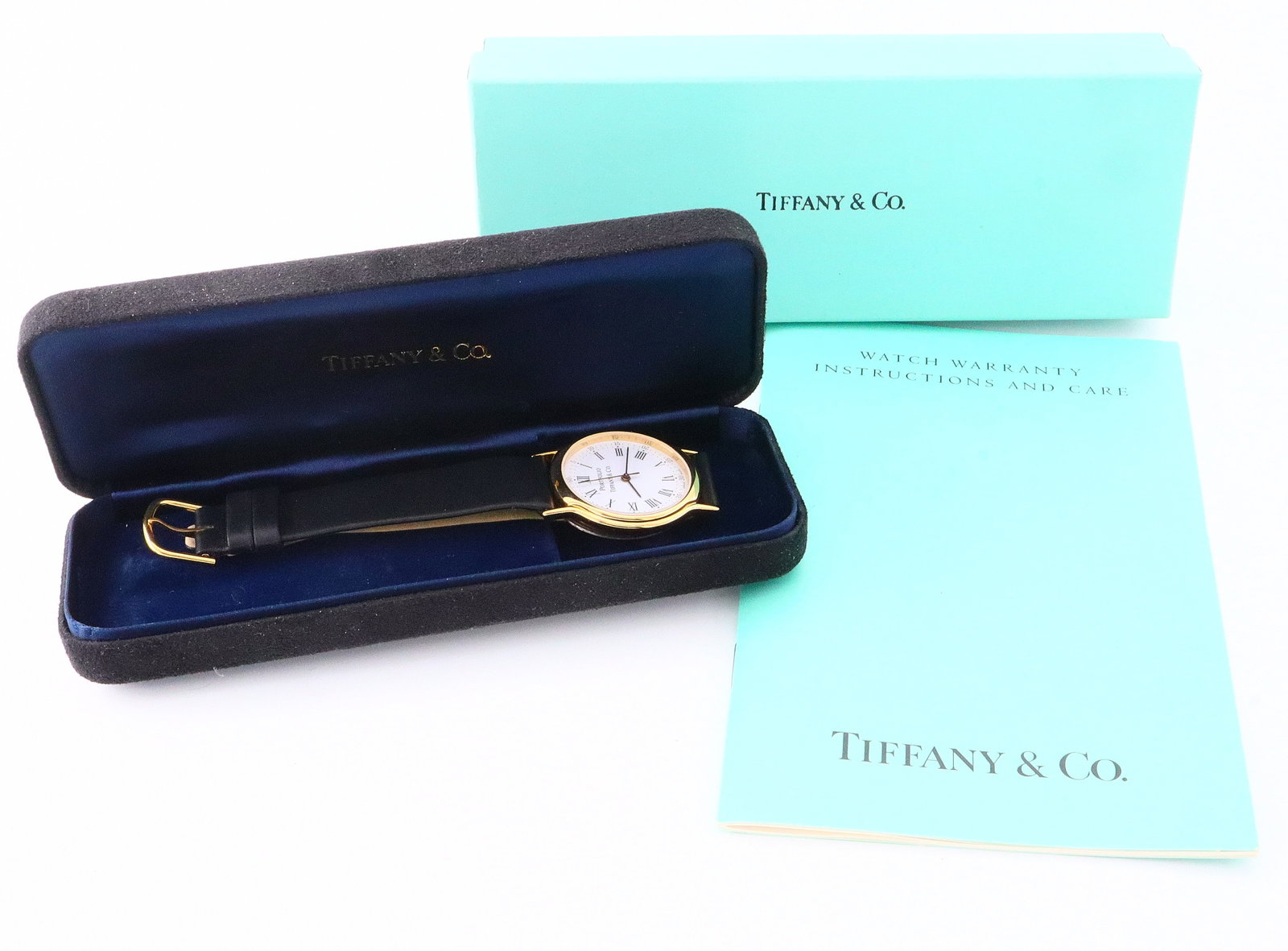 Tiffany Wristwatch: A vintage Tiffany & Co. "Portfolio" wristwatch. 32mm Gold filled case with Quartz movement, porcelain dial with Roman/Arabic numerals on original Black leather strap. Includes Tiffany case, box and