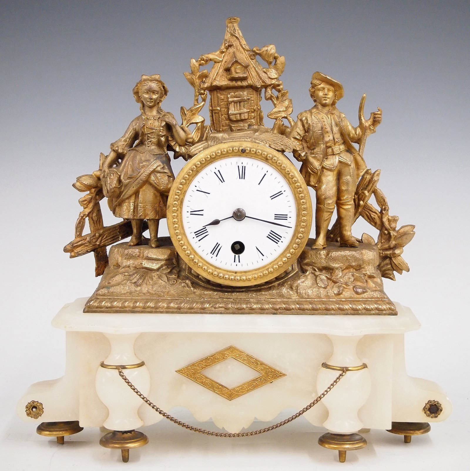French Mantel Clock: A late 19th century French Louis XVI style mantel clock. 8-day time only movement with porcelain dial and Roman numerals. Figural spelter case with a farm couple on an Onyx base. Old gilded finish